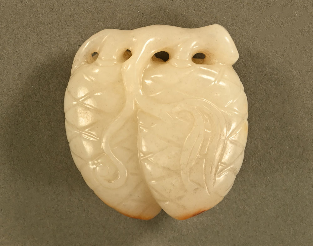 A Chinese carved jade paperweight in the form of pinecones or fruit. Height 5 cm.