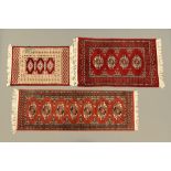 An Eastern runner and two fringed rugs,