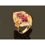 An 18 ct gold ruby and diamond set cocktail ring (see illustration).