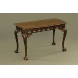 A large 19th century Georgian Chippendale style mahogany serving table, with carved Gothic motifs.