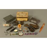 A tin containing a quantity of collectibles, including a Tiffin box, weights, napkin rings etc.