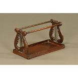 A carved mahogany lyre book library stand or shelf.