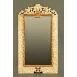A large gilt and cream painted wooden framed mirror, of large form with foliate scrollwork.