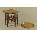 An Islamic brass topped table. Diameter 58 cm, together with an octagonal Islamic tray. Width 45.