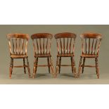 A set of four Victorian slat back kitchen dining chairs, raised on turned legs united by stretchers.
