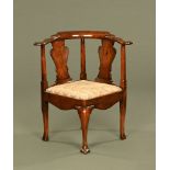 A Georgian mahogany corner armchair, with splat back, drop in seat and cabriole legs.