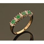 A 9 ct gold dress ring, set with clear and green coloured stones. Size O/P, 2.1 grams.