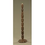 A carved wooden lamp standard, all over carved with birds and flower heads.