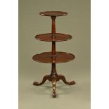 A George III mahogany circular three tier dumb waiter,