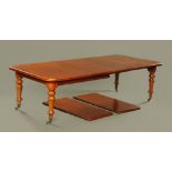 A Victorian mahogany extending dining table, with four leaves.