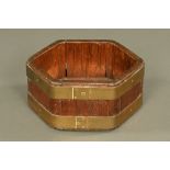 An octagonal teak brass bound trough, 19th century. Height 19 cm, width 41 cm.