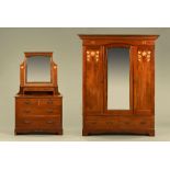 A Liberty & Co wardrobe with matching dressing table, the handles stamped to the rear L & C Patent.