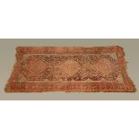 An antique Persian carpet, rectangular, the centre panel with three diamond motifs with bird,