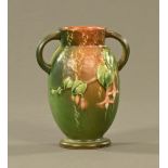 An American Rooseville Arts & Crafts two handled vase, relief moulded. Height 16 cm.