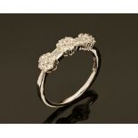 An 18 ct white gold dress ring with floral design, set with diamonds weighing +/- .58 carats.