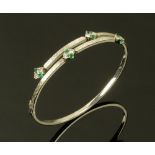 An 18 ct white gold diamond and emerald set bracelet,