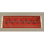 A Persian style fringed runner,