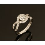 An 18 ct white gold halo ring, with twist shoulders. Total diamond weight +/- .95 carats.