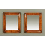 A pair of 18th century cushion framed mirrors, each with later bevelled glass.