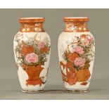 A pair of small Kutani vases, decorated with furniture, foliage and birds,