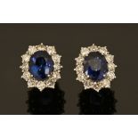 A pair of 18 ct Ceylon sapphire cluster earrings, sapphire +/- 4.2 carats, diamonds +/- .