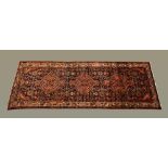 A hand knotted Persian carpet from the North West Region. 290 cm x 112 cm (see illustration).