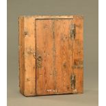 An early 18th century pine kitchen wall cupboard, with original H hinges, possibly Irish.