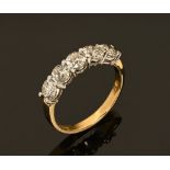 An 18 ct gold two tone five stone half eternity ring set with diamonds. weighing +/- 1.56 carats.