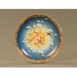 A Japanese Meiji period Satsuma bowl, decorated in typical Satsuma colours with birds and blossom.