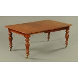 A Victorian mahogany extending dining table with leaf, with moulded edge,