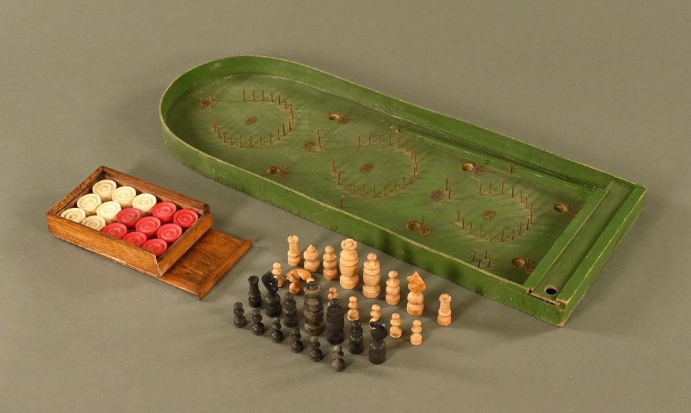 A vintage bagatelle board, together with a chess set, draughts etc.