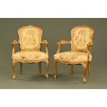 A pair of gilt painted wooden open armchairs,