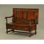 A large late 19th/early 20th century oak monks bench,