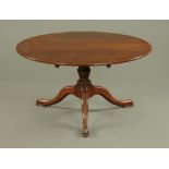 A Georgian style traditional oak circular dining table,