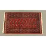 A Bokhara rug, rectangular with fringed ends,