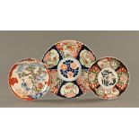 A Japanese Imari charger and two smaller Imari plaques. Largest diameter 34.5 cm.