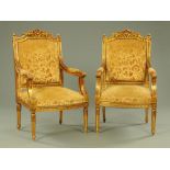 A pair of gilt painted and wooden armchairs,