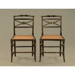 A pair of parcel gilt and ebonised Regency cane side chairs with ring turned cross stretchers and