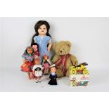 A group of vintage dolls, to include a hard plastic walker doll, a cloth doll, costume dolls,