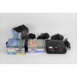 A Sega 16-Bit Megadrive II games console, together with two controllers, a mains adapter,
