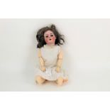 An antique Simon & Halbig bisque head doll, with impressed Size 8 mark to the back of the head,