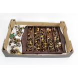 A box of modern metal brass coloured doll house accessories together with a wooden stand,