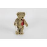 A 1950's Schuco Tricky Yes/No teddy bear, having brown mohair covered body, amber glass eyes,