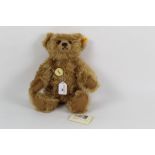A Steiff Classic teddy bear, 004421, having circular chest tag, cinnamon brown coloured fur,