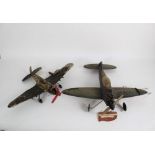 Two vintage motorised spitfire plane models on string, the largest measuring 46 cm long,