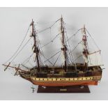 A detailed wooden model of the USS Constitution frigate boat, with extensive rigging,