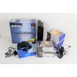 A box of Playstation games consoles, to comprise a PS Vita hand held console, a Playstation 2,