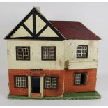 A 20th century wooden two storey dolls house, with metal shutter windows,
