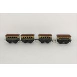 A group of four 1930s Hornby 0 gauge Pullman coaches, with brown roofs, and comprising "Marjorie",
