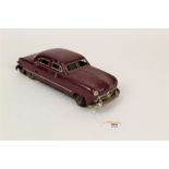 A 1940s/50s German SG Gunthermann tin plate and clockwork "Ford Sedan", with maroon body,